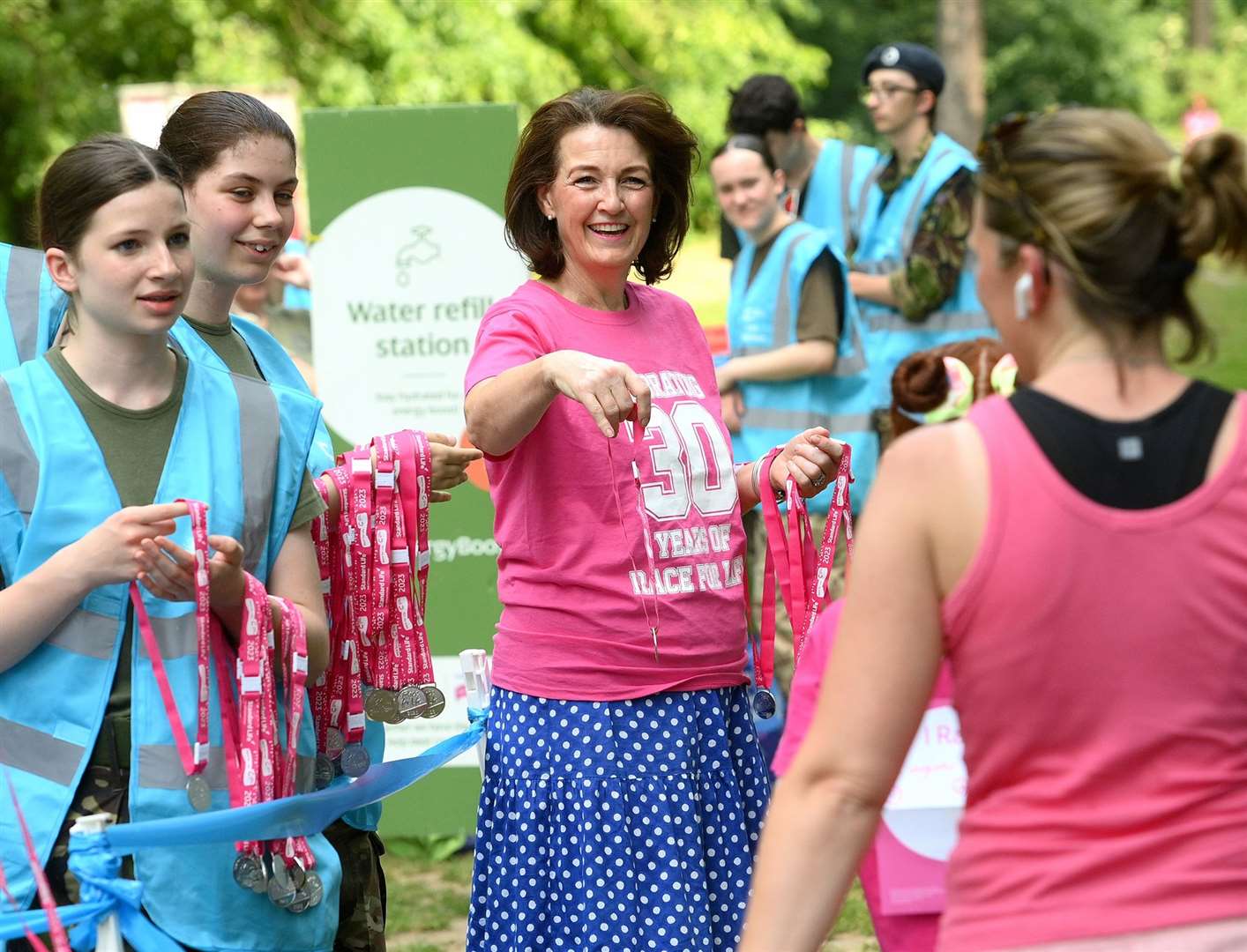 Jo Churchill, MP, helping give out medals. Picture: Mecha Morton