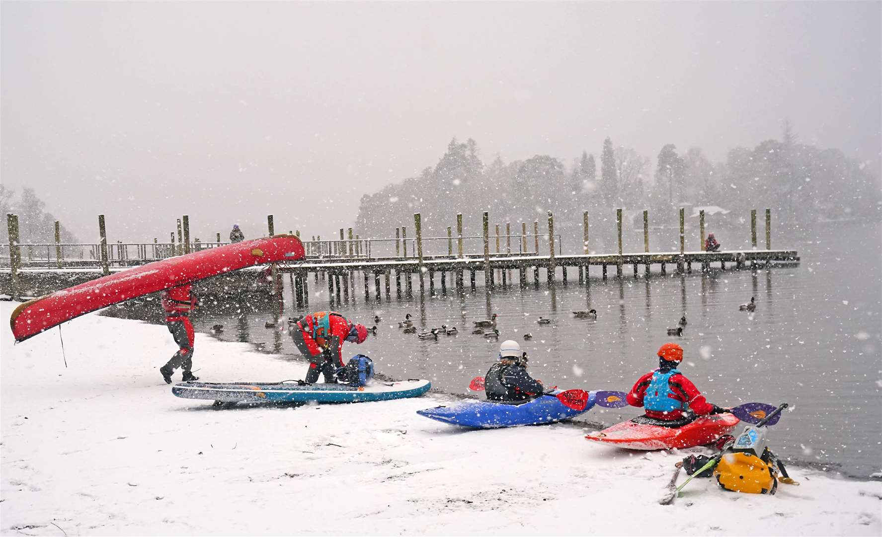 Canoeists, kayakers and paddleboarders make it on to Derwent Water, in the Lake District (Owen Humphreys/PA)