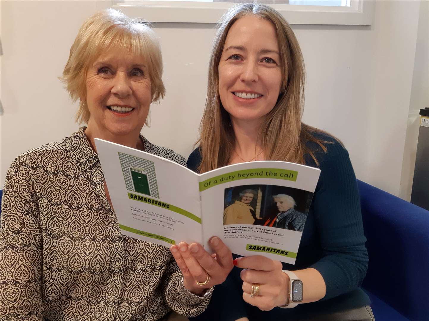 Volunteers Di Allum, left, and Caroline Lewis read up on the branch’s history