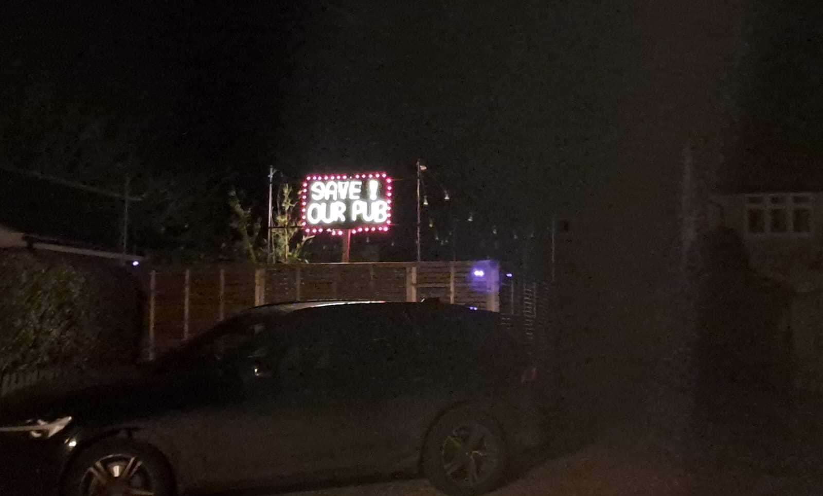 A 'Save Our Pub' sign at a house opposite the village hall in Brandeston, near Woodbridge and Framlingham. Picture: Ross Waldron