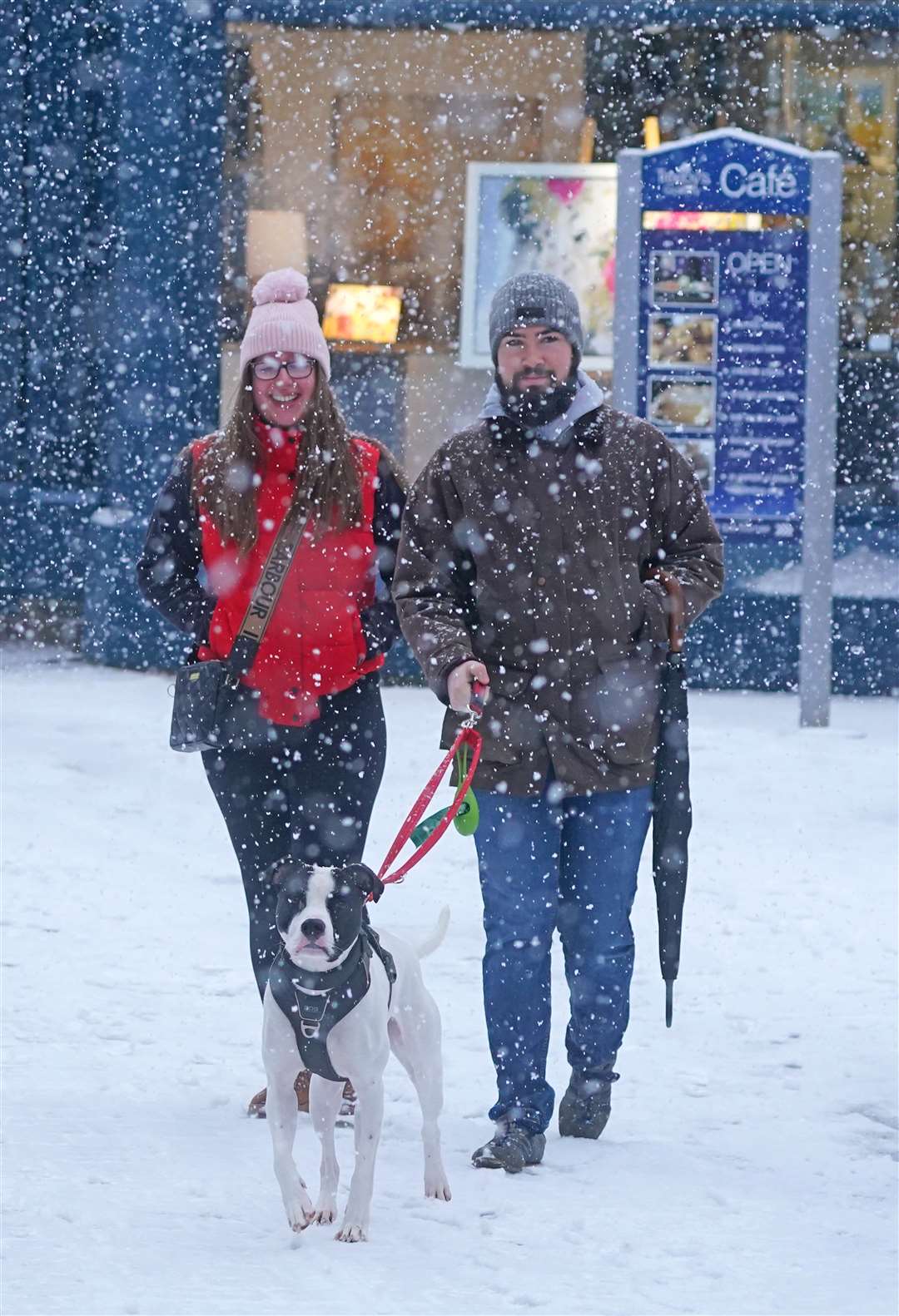 Another couple wrap up to walk their dog (Owen Humphreys/PA)