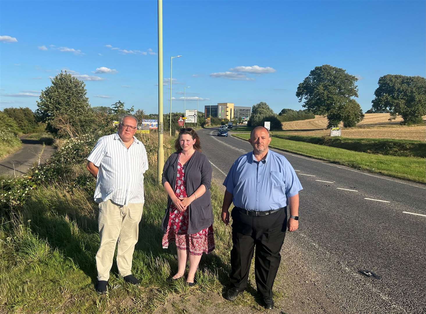 Suffolk County Councillors, from left: David Roach, Bobby Bennett and Joe Mason next to the A1307, and close to the proposed site for the anaerobic digestion plant.Contributed picture